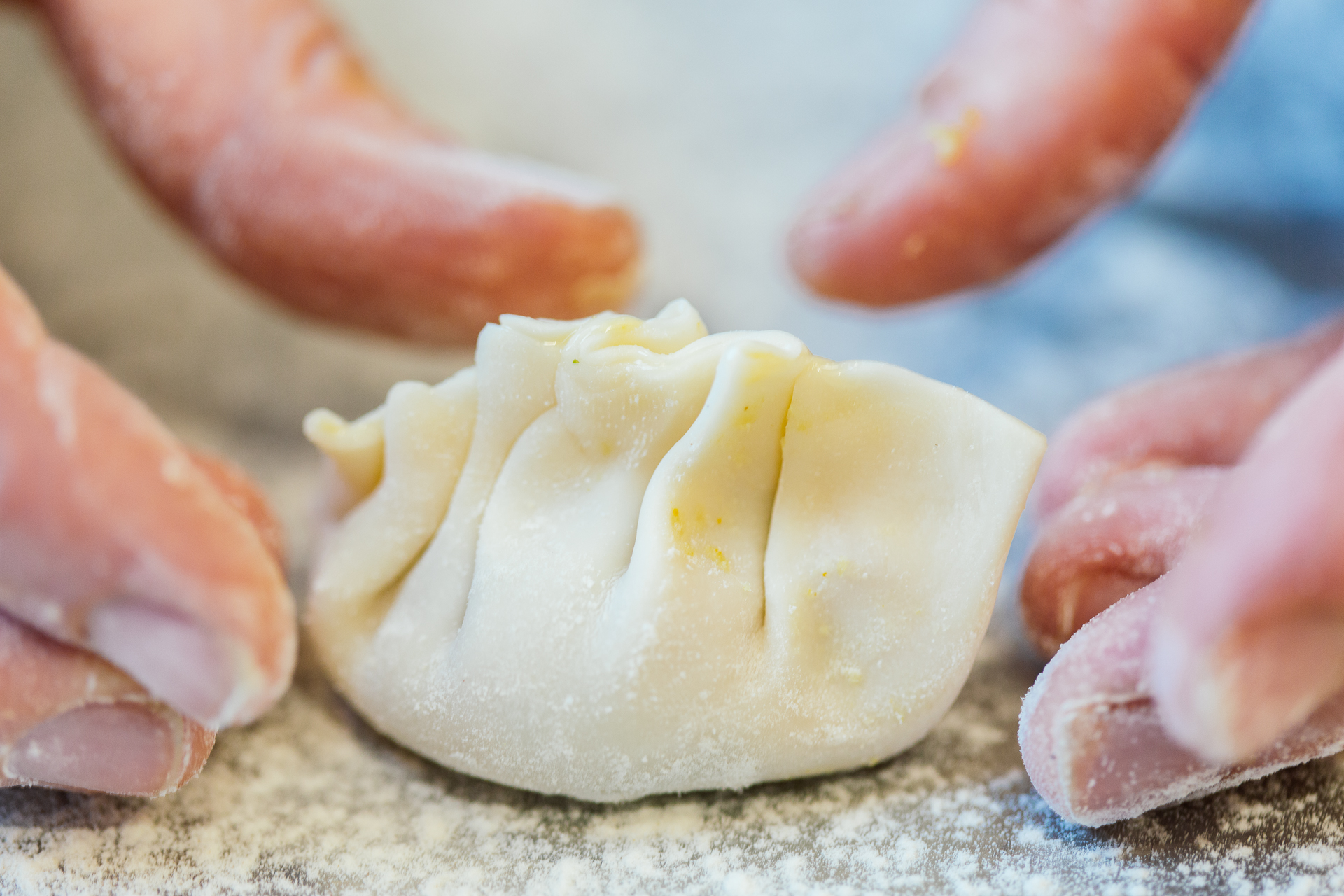 Hand-folded dumpling, dusted in flour